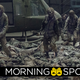 A group of zombiefied soldiers shuffle over the fallen bodies of other military-gear-clad corpses.